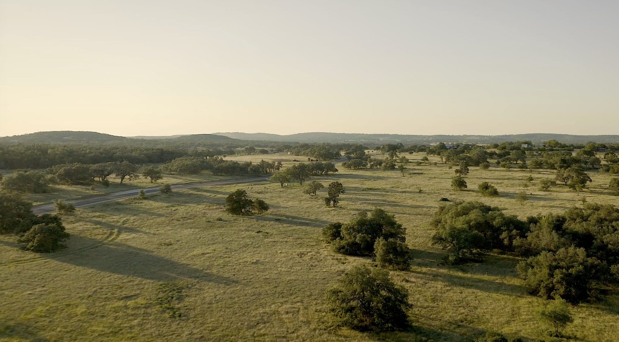 Aerial view of open Hill Country meadow and oak trees at Prochnow Oaks Ranch